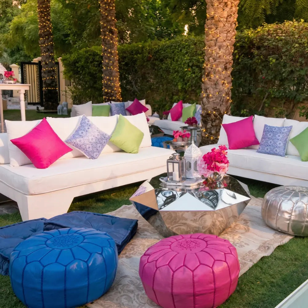 White 3-seater lounge with clean lines, paired with colorful throw pillows and a metallic coffee table, perfect for upscale event seating.