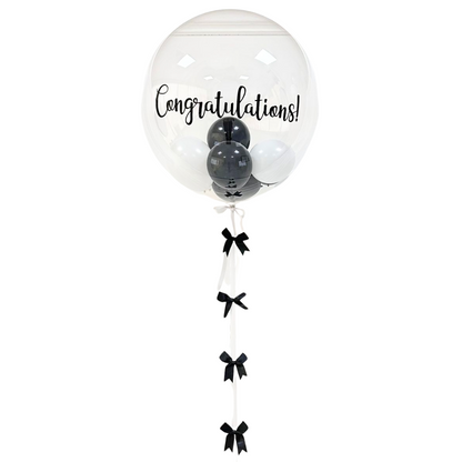 Bubble Filled Helium Giant Balloon with black and white balloons inside, featuring a handmade ribbon tail, perfect for enhancing any celebration or party atmosphere.