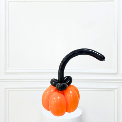 Orange Pumpkin Balloon with a black stem, perfect for adding a playful touch to party decorations or gifts.