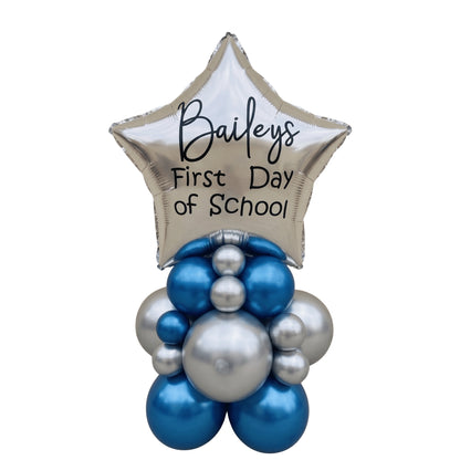 A first day of school balloon bouquet featuring a metallic silver star foil balloon with the text &