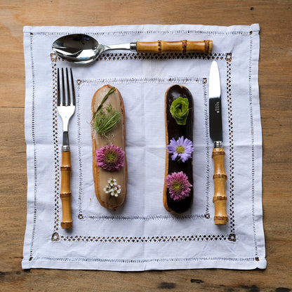 Bamboo Light Cutlery Set of 5 with flower-topped dessert and knife close-up.