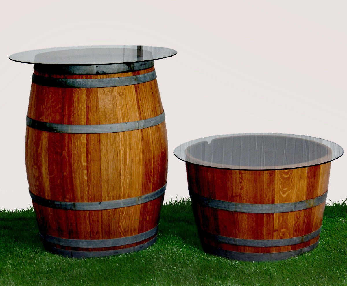 Rustic Wine Barrel Table 225ltr with glass top, featuring two barrels on grass, ideal for creating unique cocktail or bar areas at events.