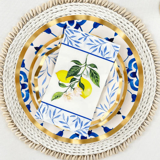 A porcelain platter with Capri Coast paper guest towel napkins featuring a lemon and leaf design. Ideal for elegant dining setups and parties. From Party Social's tableware collection.