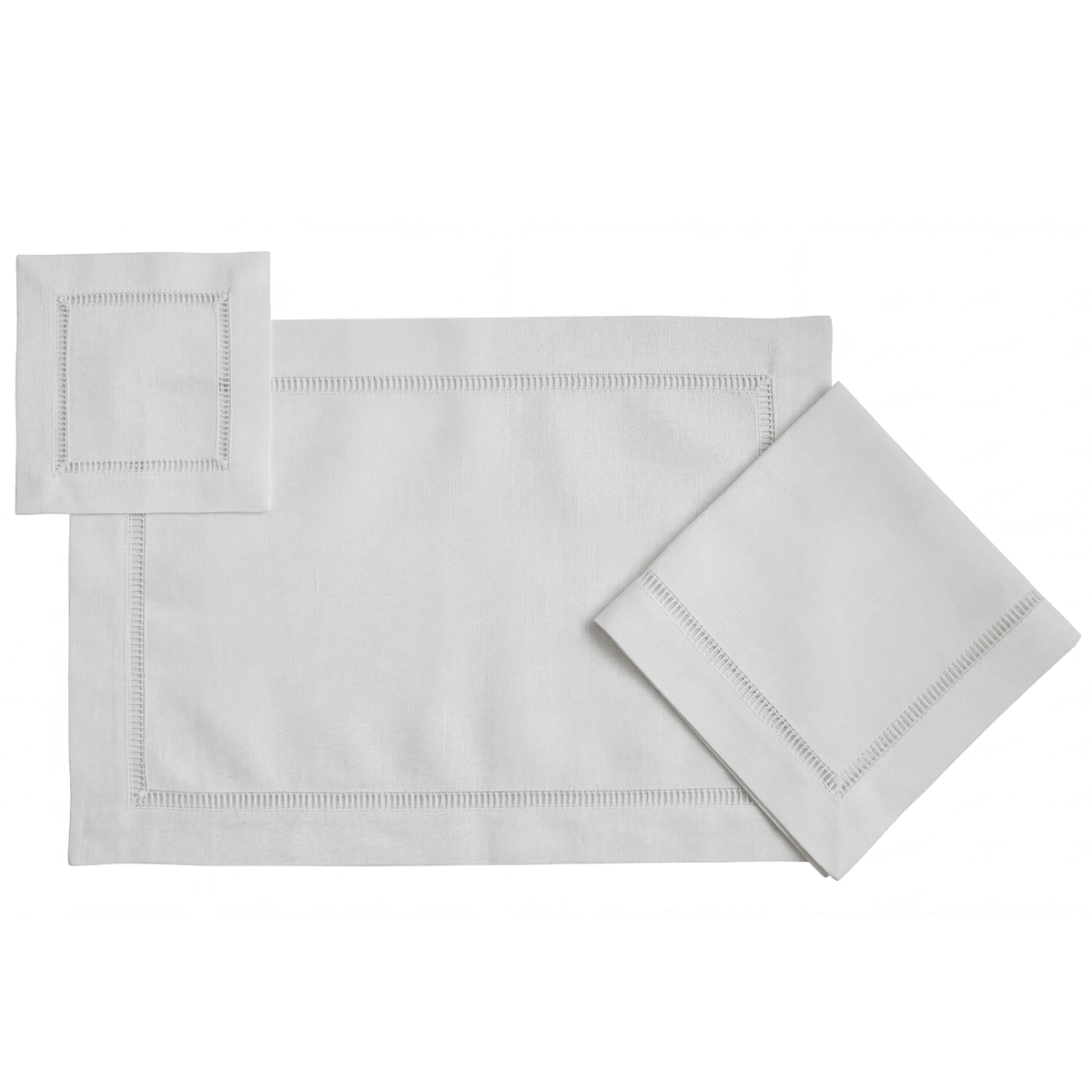 Classic Border Pure Linen Coaster in a set of four, displayed with matching white hem-stitched placemat and napkins, showcasing elegant tableware for special occasions.