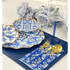 Blue-stemmed glass adds elegance to the decorative table setting, complemented by gold-accented plates and matching blue-handled flatware, enhancing any event&