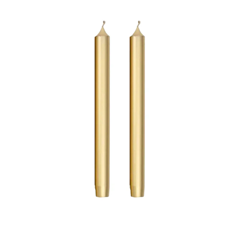 Two slim gold taper candles standing upright side by side on a plain white background.
