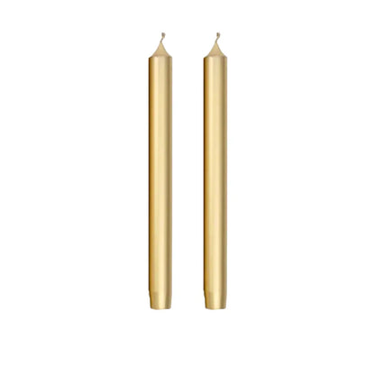 Two slim gold taper candles standing upright side by side on a plain white background.