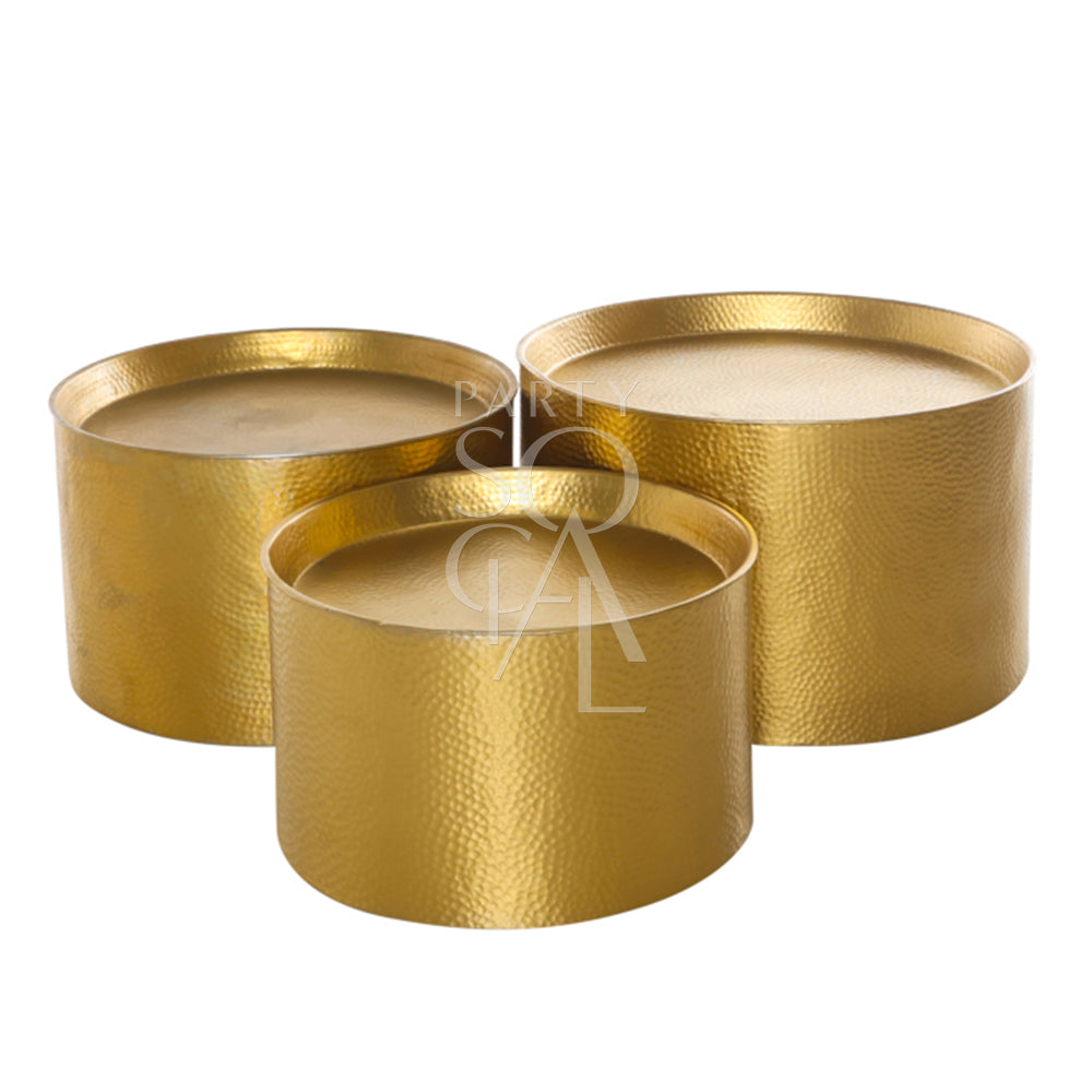 ALUMINIUM COFFEE TABLE in Moroccan-inspired hammered design, shown as a gold cylindrical shape, available in three sizes for versatile event settings.