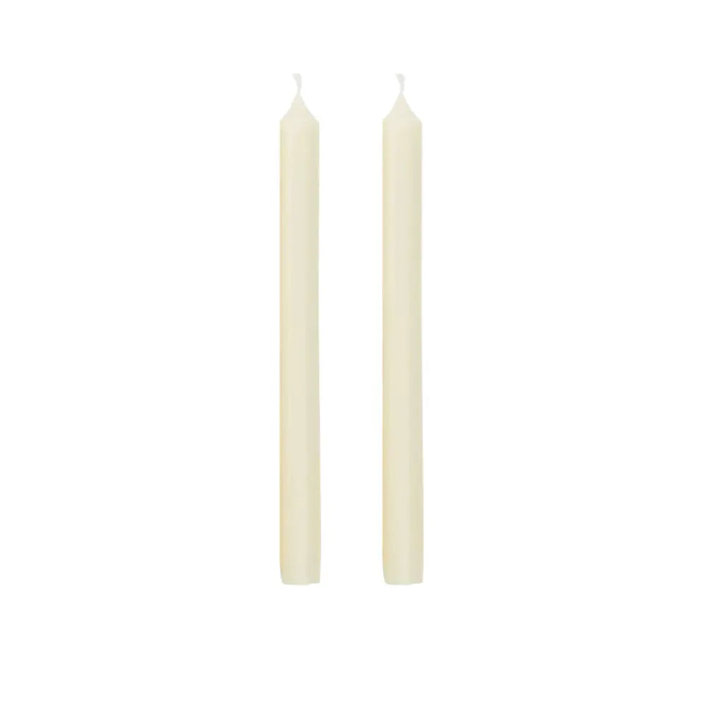 Two slim cream-colored taper candles standing upright side by side on a plain white background.