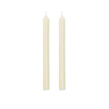 Two slim cream-colored taper candles standing upright side by side on a plain white background.