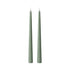 Two slim, pointed taper candles in a muted sage green color, standing upright side-by-side on a plain white background.