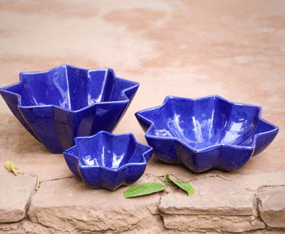 Group of Marrakesh Star Ceramic Bowls, one with wavy edge, star design, and green leaf detail. Perfect for serving homemade dishes.