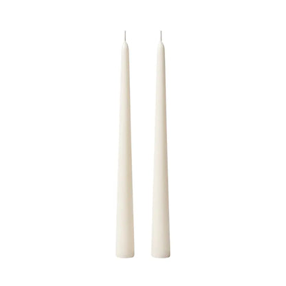 Two slim white taper candles standing upright side by side on a plain white background.