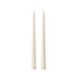 Two slim white taper candles standing upright side by side on a plain white background.