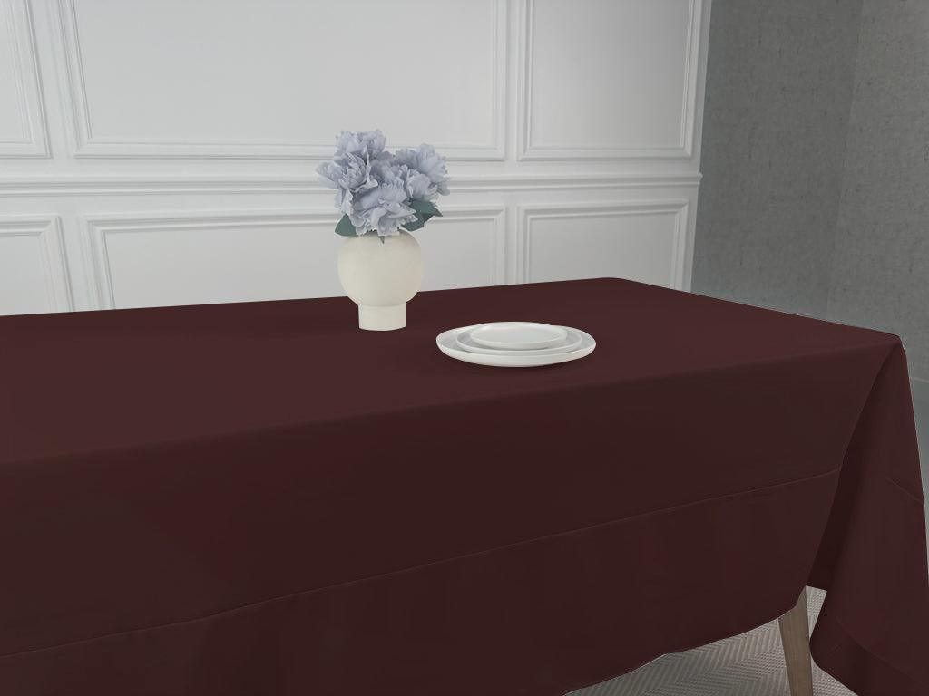 A Polycotton Tablecloth with a vase of flowers on a table.
