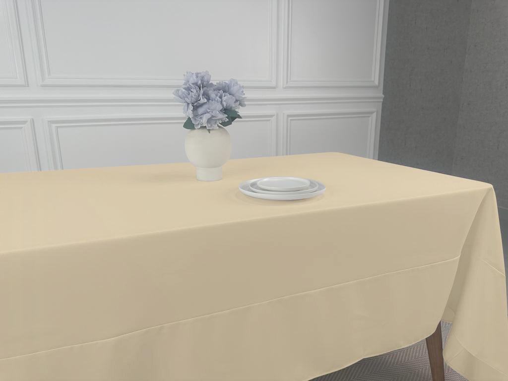 A Polycotton Tablecloth with a vase of flowers and plates on a table. Perfect for any event, easy to wash and reuse. Available in 3 sizes.