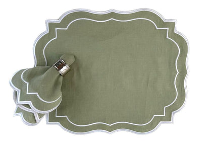 Scalloped Linen Napkins - 4 per pack, elegantly set on a green place mat with a napkin holder and silver ring