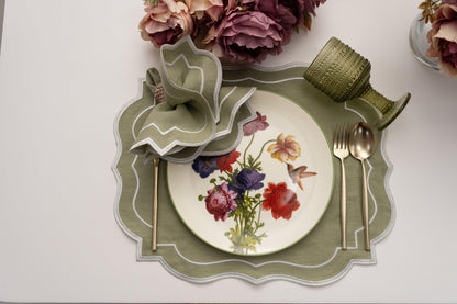 Scalloped Linen Placemats with floral design, silverware, and flower vase on a plate
