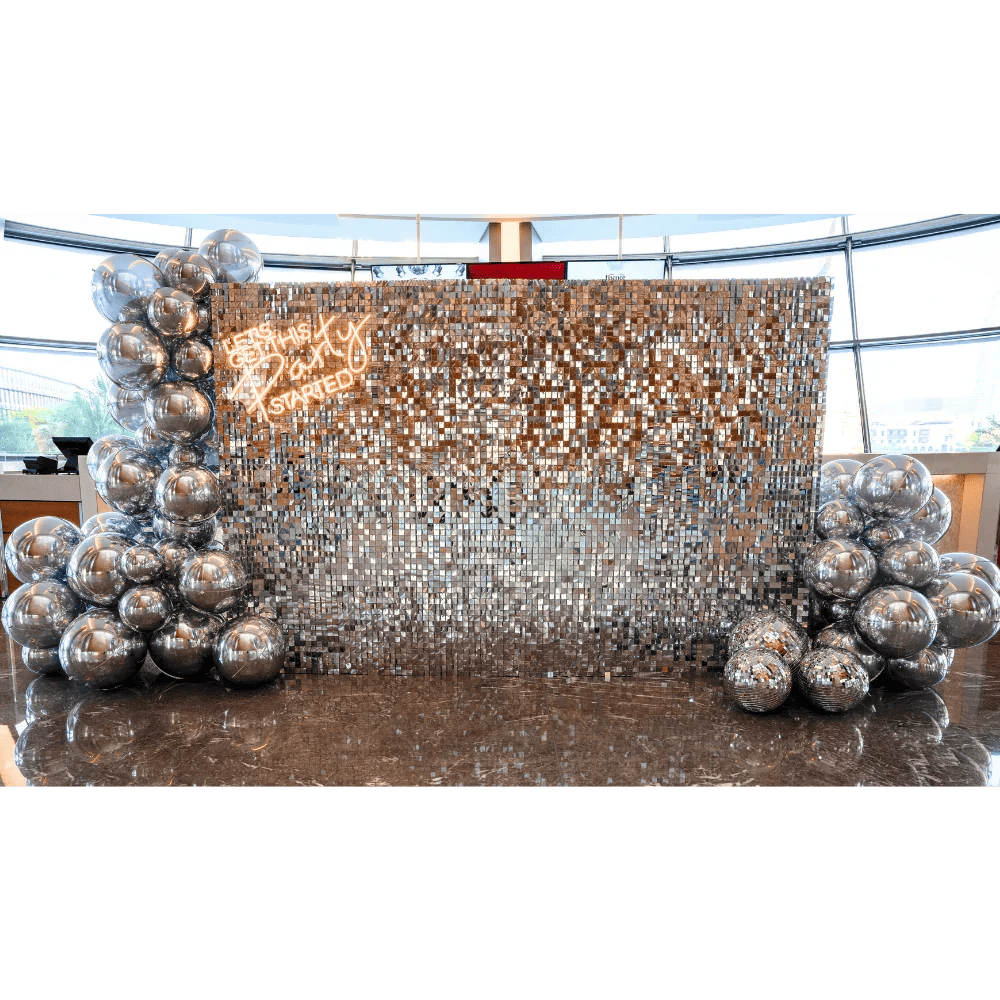 Silver Sequin Wall Balloon Backdrop with LED Neon Sign, featuring silver balloon decorations; ideal for elegant events like weddings and parties.
