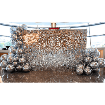 Silver Sequin Wall Balloon Backdrop with LED Neon Sign, featuring silver balloon decorations; ideal for elegant events like weddings and parties.