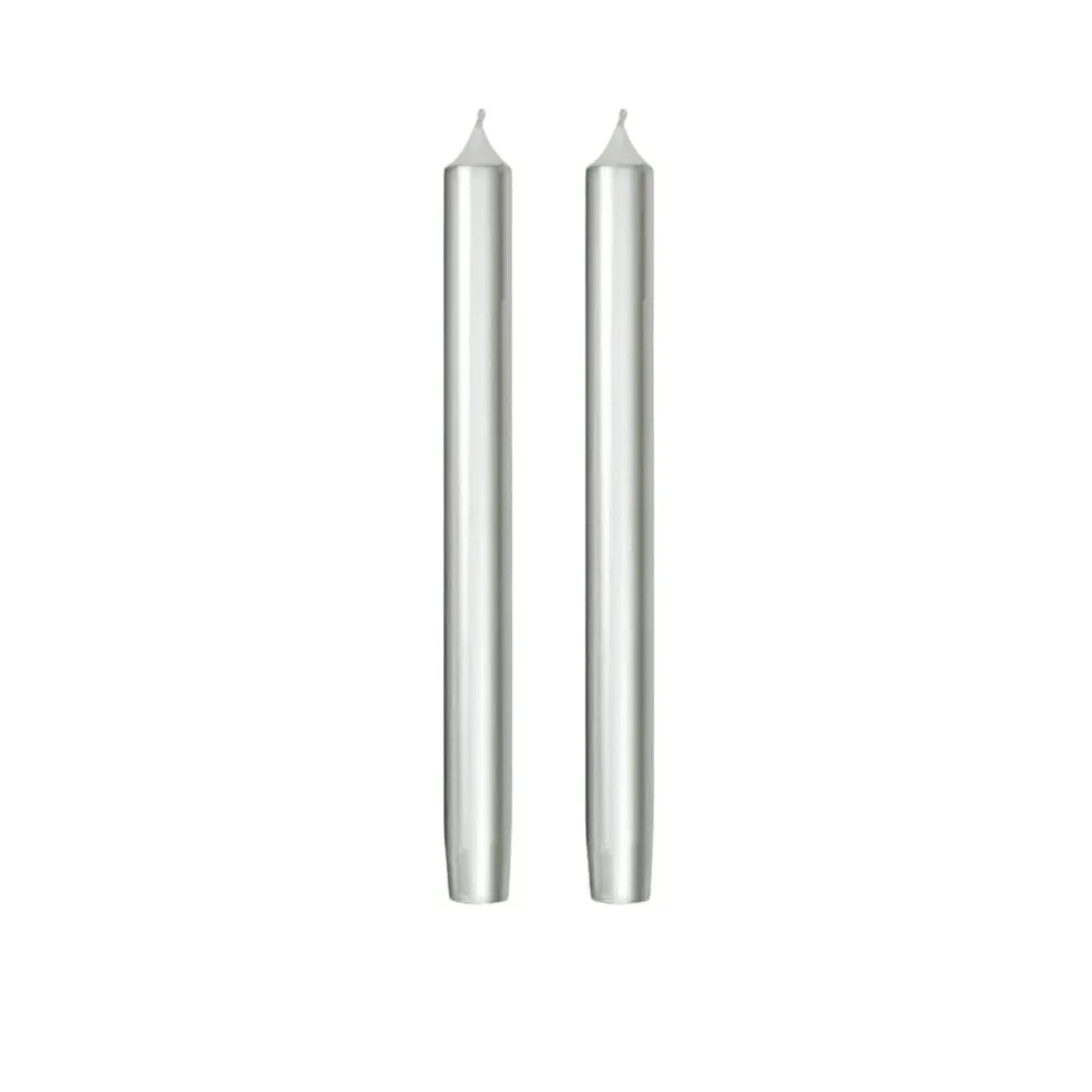 Two slim silver taper candles standing upright side by side on a plain white background.