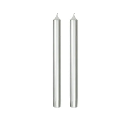Two slim silver taper candles standing upright side by side on a plain white background.